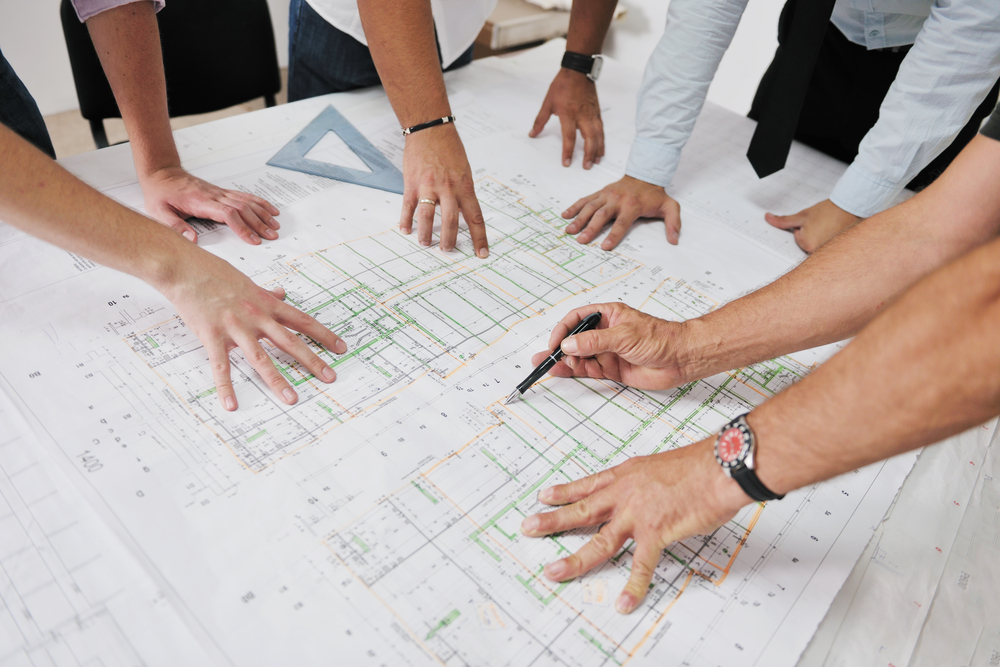 Team of architects people in group  on construciton site check documents and business workflow