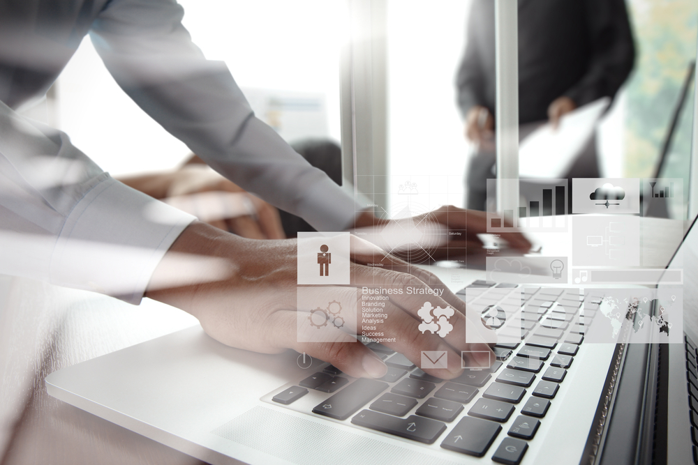 double exposure of new modern laptop computer with businessman hand working and business strategy as concept